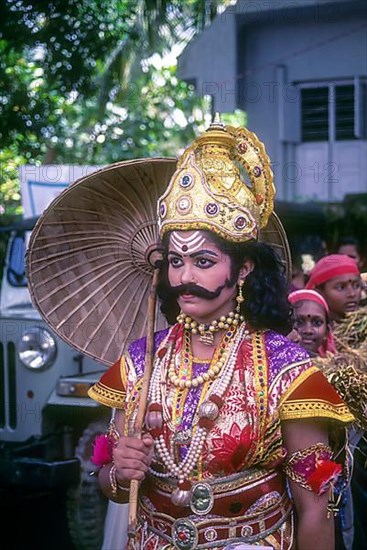 Maveli or king Mahabali model dressing with ornaments and umbrella for onam festival in Kerala