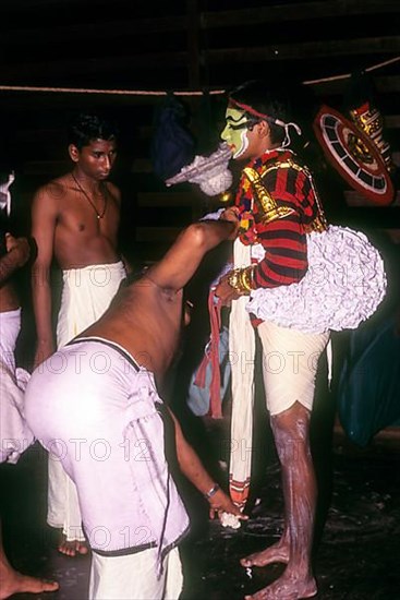 Koodiyattam Kodiyattom actor being fitted with his costume