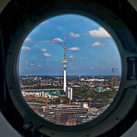 City view of the Heinrich Hertz Tower through the porthole windows in the spire of the main church of St. Petri