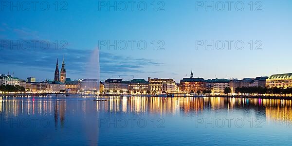 Inner Alster with Alsterfontaine and city skyline in the evening