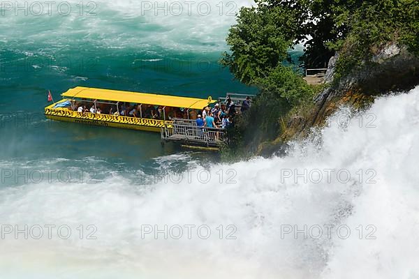 Tourist boat at the jetty of the viewing rock in the Rhine Falls