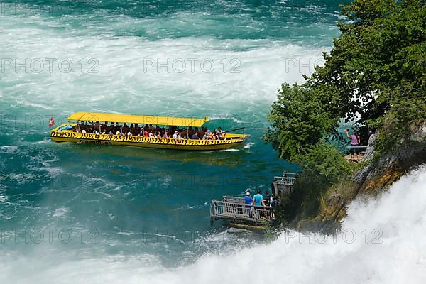 Tourist boat at the jetty of the viewing rock in the Rhine Falls