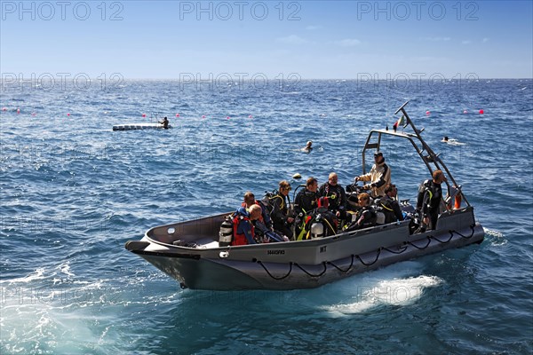 Divers sitting in aluminuim boat