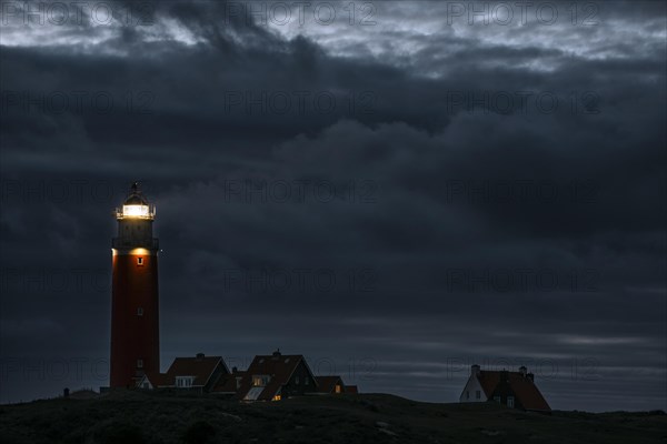 Eierland lighthouse with lantern light over the Wadden Sea at night on the Dutch island of Texel