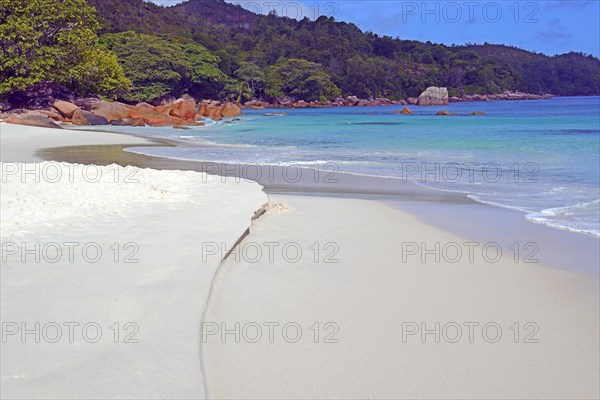 Beach and rocks of Anse Lazio in the evening