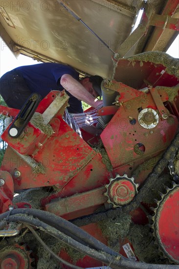 Farmer working on round baler