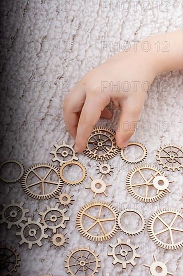 Hand holding gear wheels as the concept of mechanism