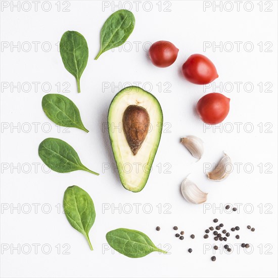 Herbs vegetables around avocado