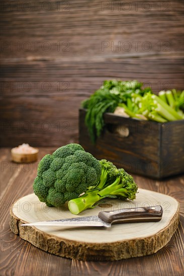 Fresh broccoli on wooden cutting board
