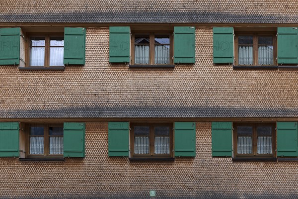 Allgaeu house with shingle facade and shutters