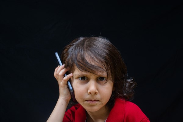 Little boy hold smartphone as modern mobile communication gadget