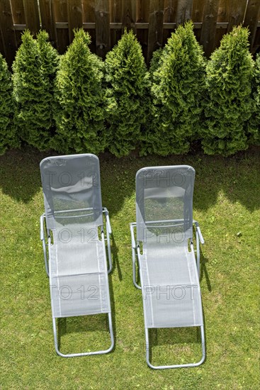 Two garden loungers in a meadow