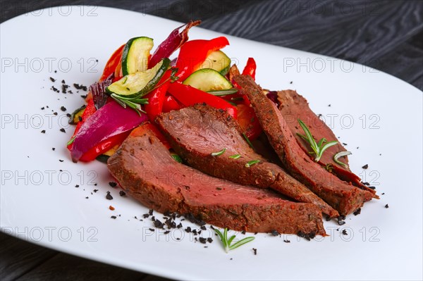 Roasted beef cutted on slices with grilled bell pepper