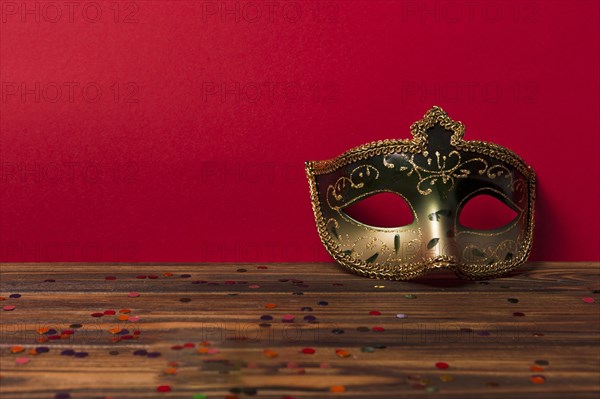 Carnival mask near red wall