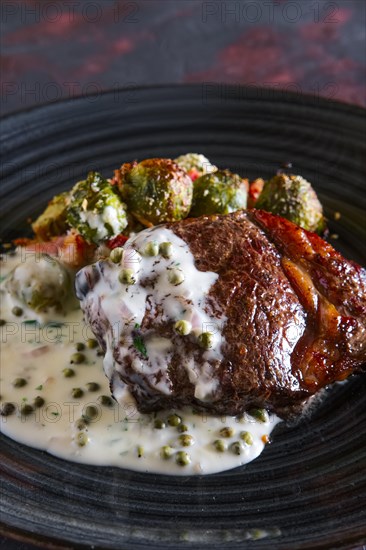Fried beefsteak with Brussels sprouts and creamy pea sauce