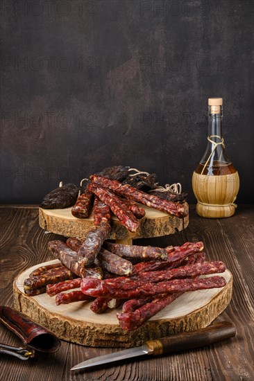 Different kinds of sausages on wooden background