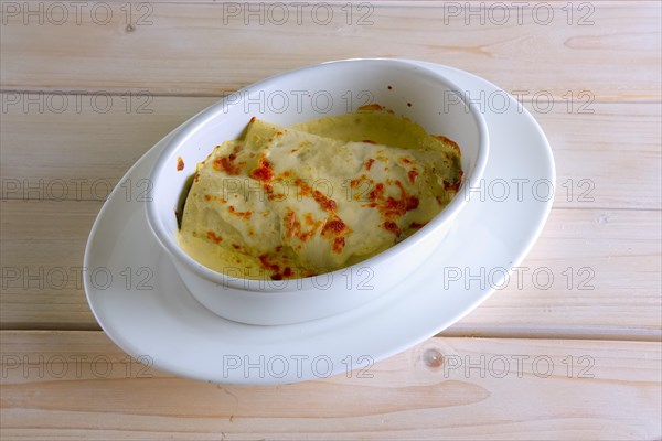 Thin pancakes stuffed with meat and covered with melted cheese