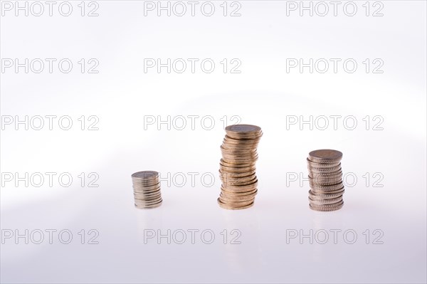 Turkish Lira coins on three piles on white background
