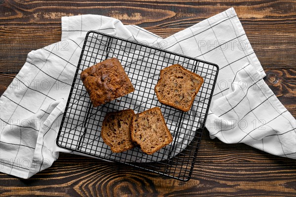 Overhead view of biscuit cake with walnut on baking grid