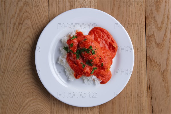 Top view of meatballs with rice on wooden table on wooden table