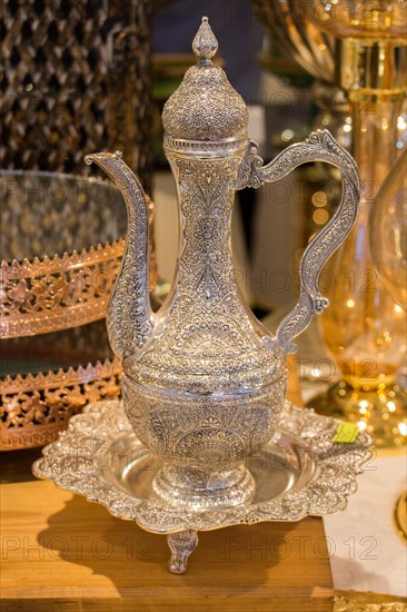 Ancient metal jug in oriental style in antique market