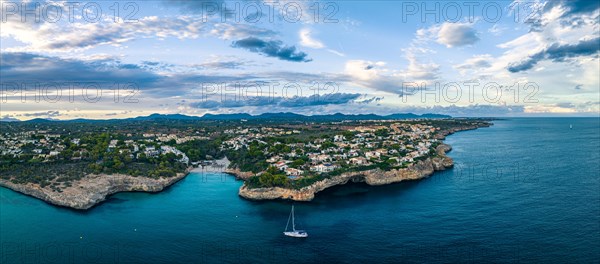 Sunset over Cala Anguila-Cala Mendia from a drone