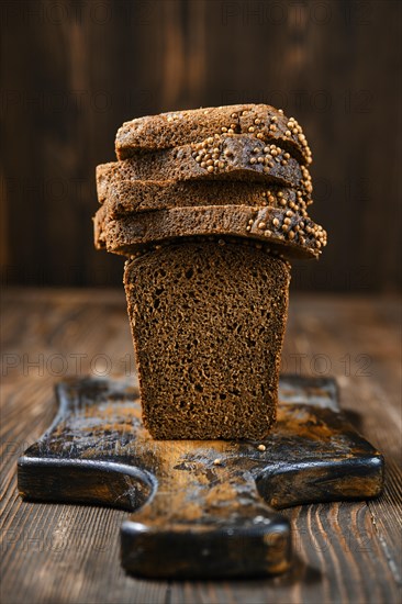 Closeup view of fresh rye brown bread on wooden cutting board