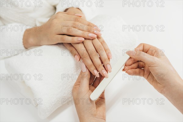 Healthy beautiful manicure and manicurist with file