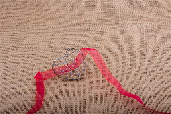 Band and Heart shaped cage on linen canvas