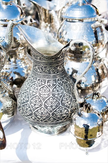 Ancient metal jug in oriental style in antique market