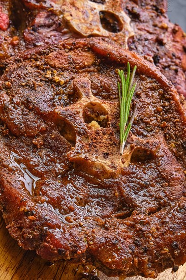 Macro photo of grilled lamb neck on wooden cutting board