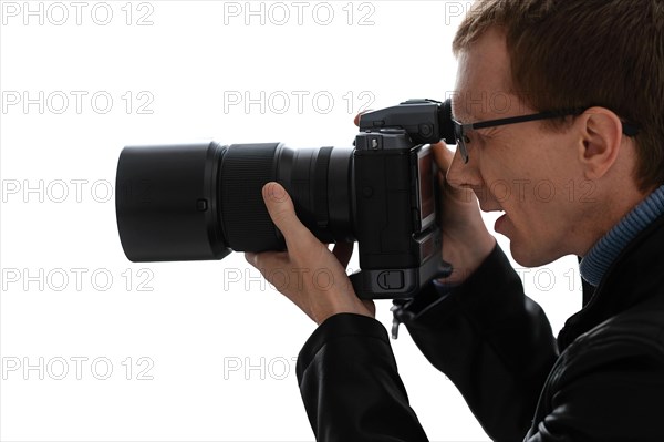 Close up portrait of photographer with camera on white background