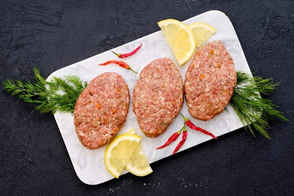 Uncooked cutlet with minced beef meat and cabbage ready for cooking