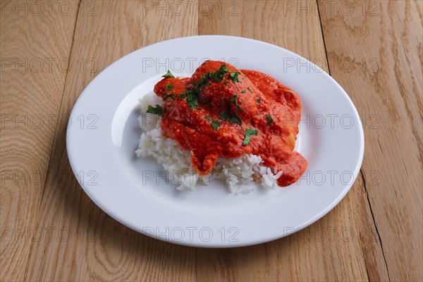 Meatballs with rice on wooden table on wooden table
