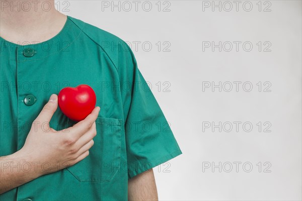 Nurse showing plastic heart