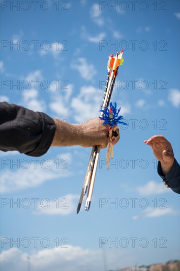 Hand holding old style wooden arrows