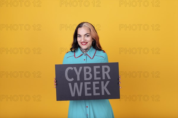 Beautiful woman holding a Cyber Week sign. Commercial concept. Commerce