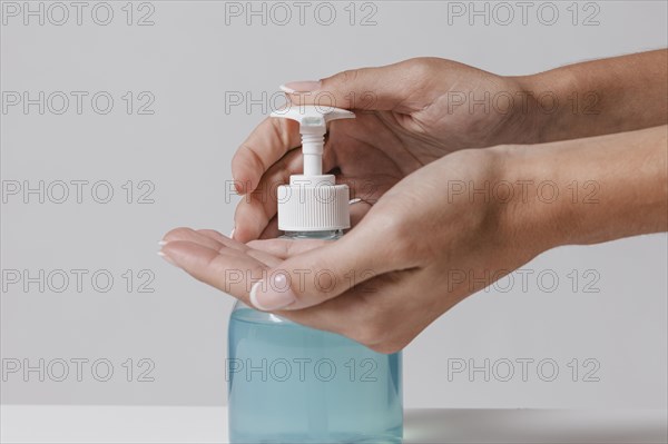 Using gel hydroalcoolique hand sanitizer from bottle. Resolution and high quality beautiful photo