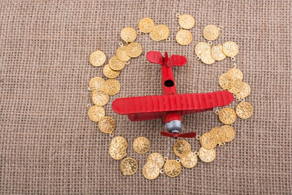 Fake gold coins around the retro model airplane