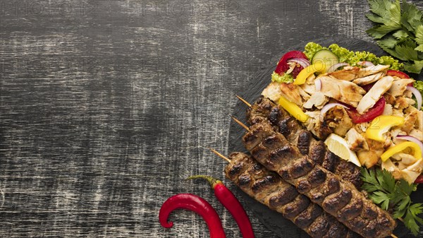 Flat lay tasty kebab with copy space salad
