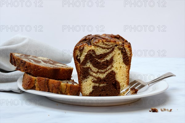 Marble cake with cake fork on plate