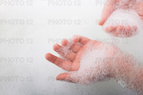 Hand washing and soap foam on a foamy background