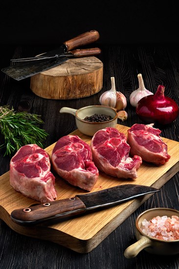 Chopped fresh lamb shank steak with spice on cutting board with spice