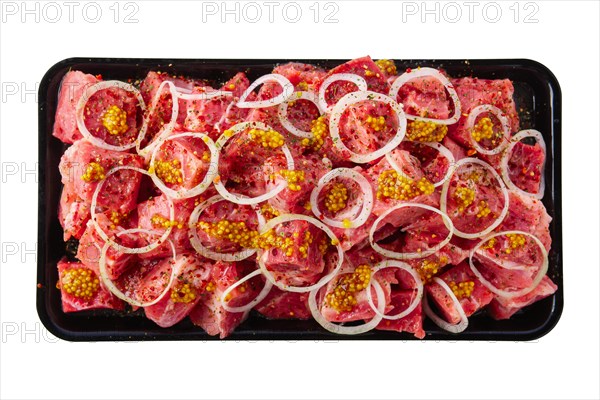 Tray with marinated meat cutted on pieces and ready for shashlik or kebab isolated on white