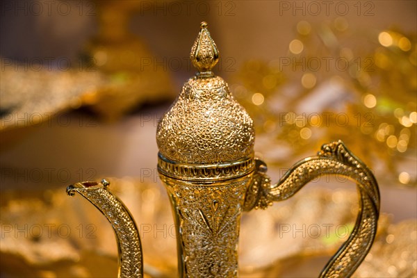 Ancient metal jug in oriental style in antique market