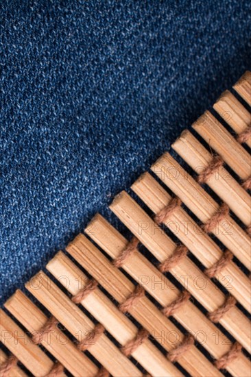 Straw mat placed on denim canvas as a background