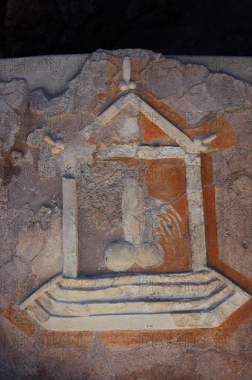 Stone relief of a penis as a reference to the brothel
