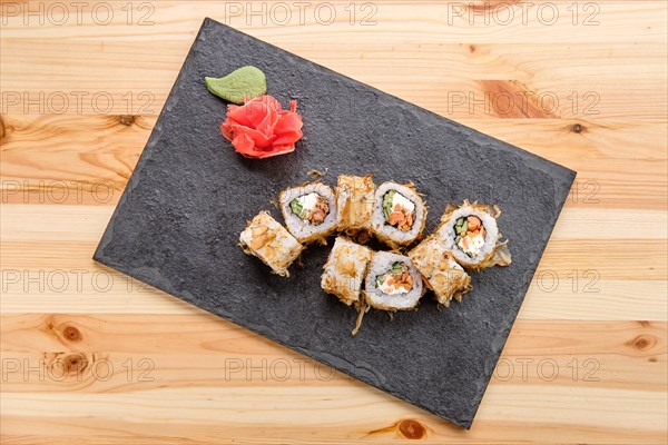 Smoked salmon rolls with cucumber on slate plate