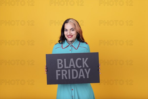 Beautiful woman holding a Black Friday sign. Commercial concept. Commerce