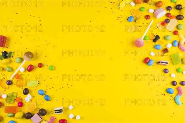 Various colorful candies lollipops yellow surface. Resolution and high quality beautiful photo